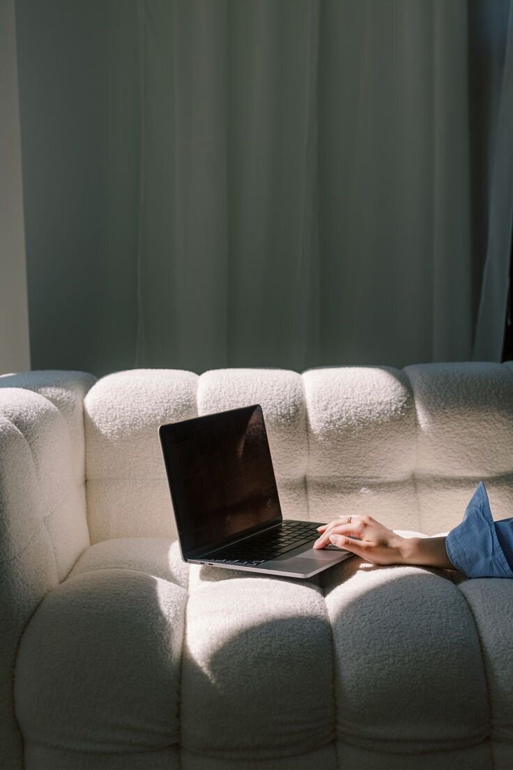 Workspace Stock Image + Video _ Woman using lapop that's placed on couch