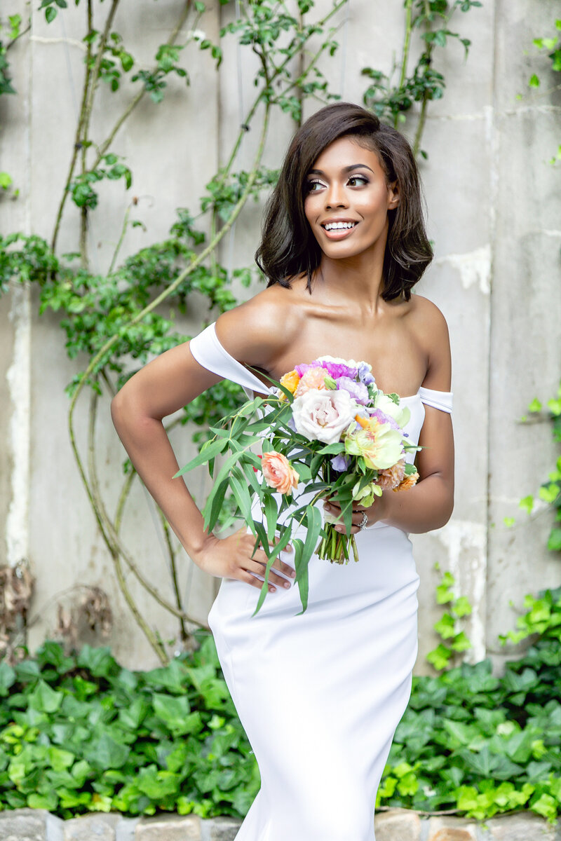 Black Bride portrait on her wedding day in white gown holding her bouquet at The Swan House in Atlanta photographed by Bonnie Blu Studios