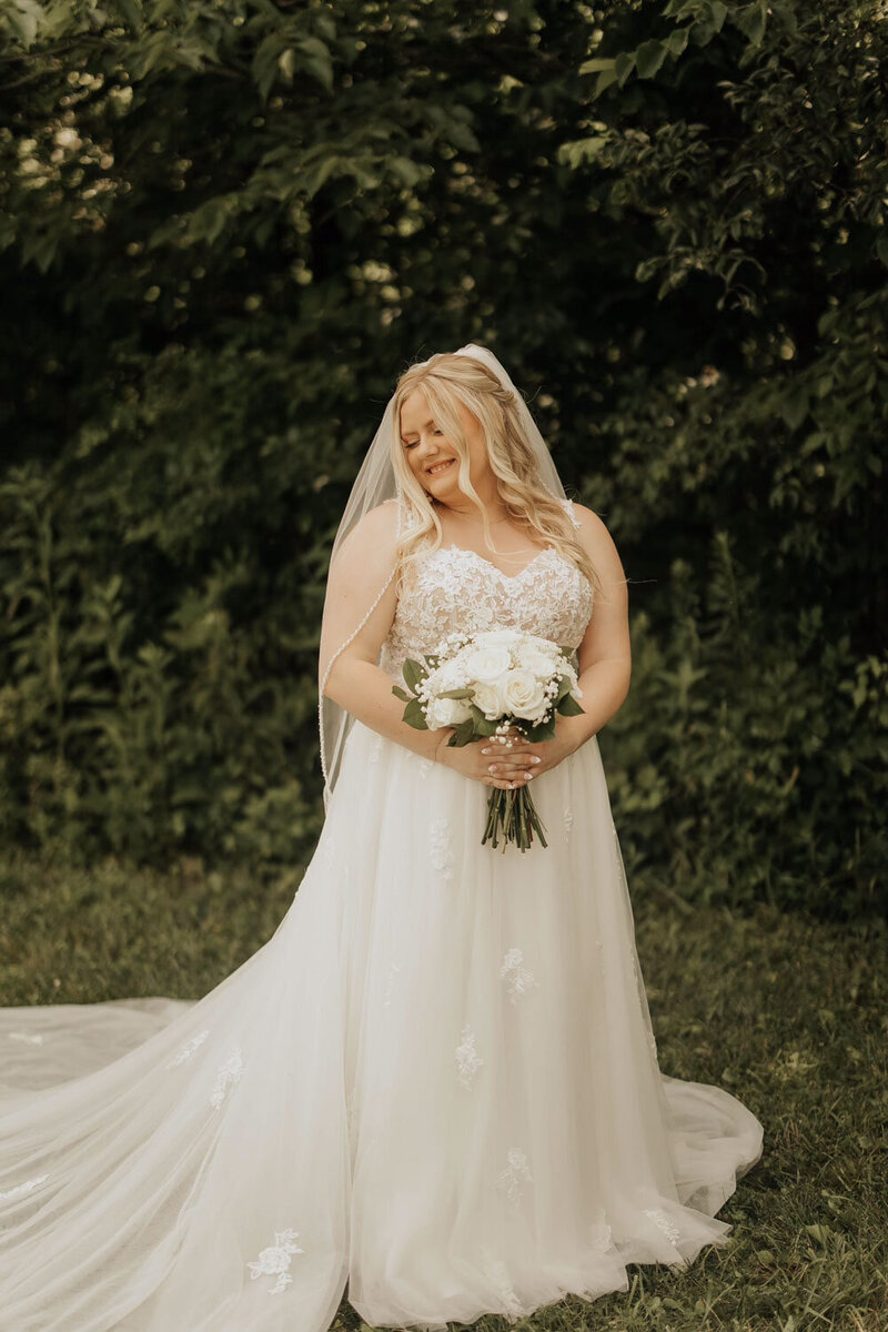 Pretty bride holding her floral bouquet