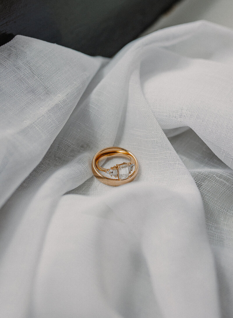 Two gold rings on a white sheet