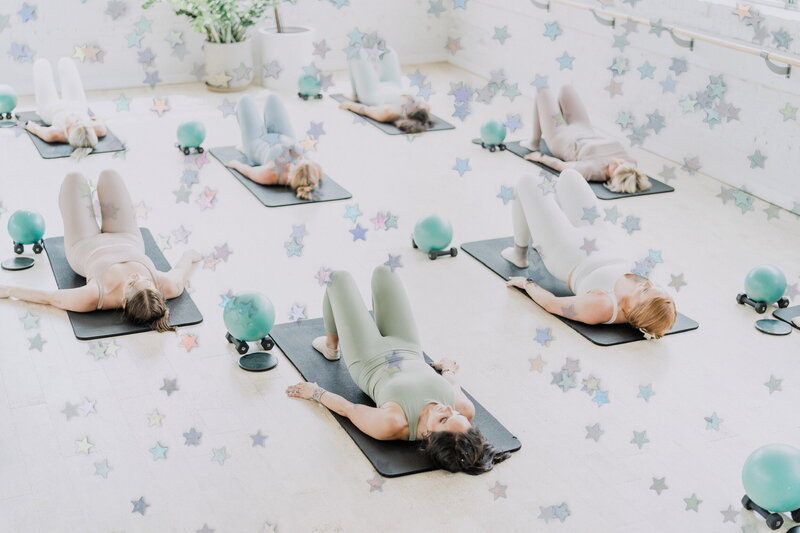 women on yoga mats in a workout studio