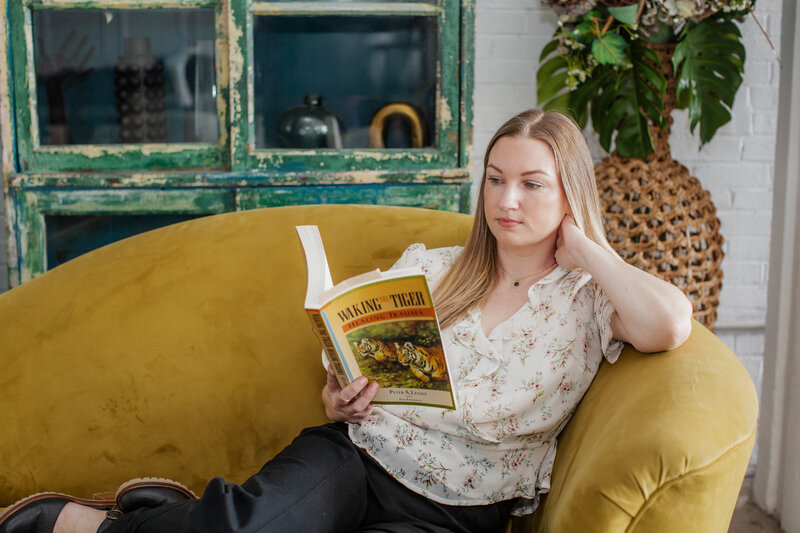 gray couch with pillows, plants, and tables surrounding it