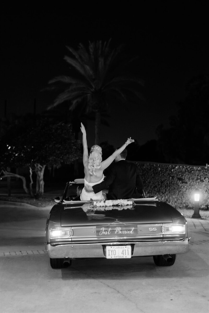 Wedding reception getaway car at the country club of Orlando by orlando wedding photographer 