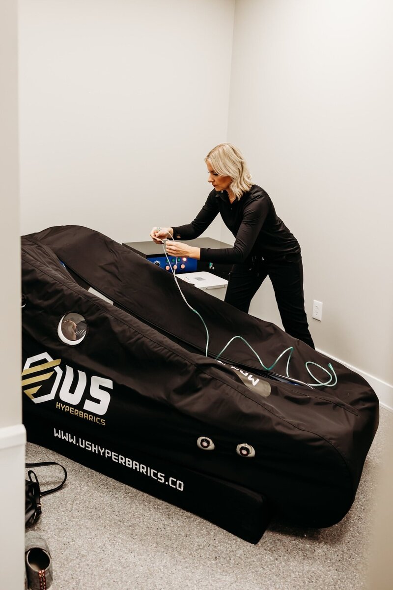 Woman setting up the hyperbaric oxygen chamber