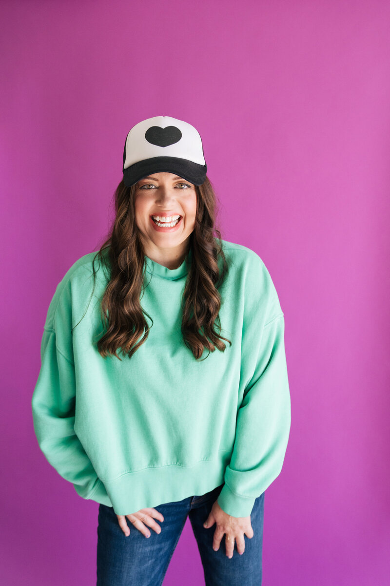 heather crabtree in teal sweatshirt with black and white hat