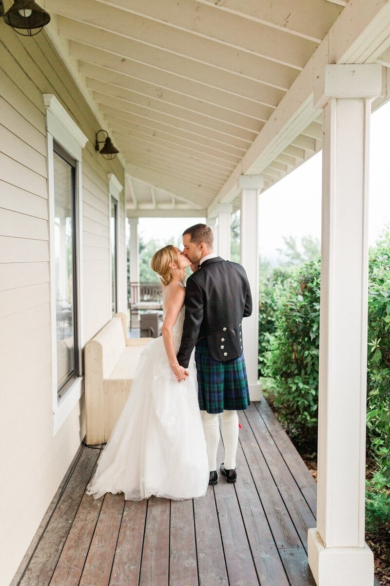 This romantic photograph captures the bride and groom taking an evening walk on the beautiful grounds of The Ridge in Okotoks, creating a serene and intimate moment at their wedding venue.