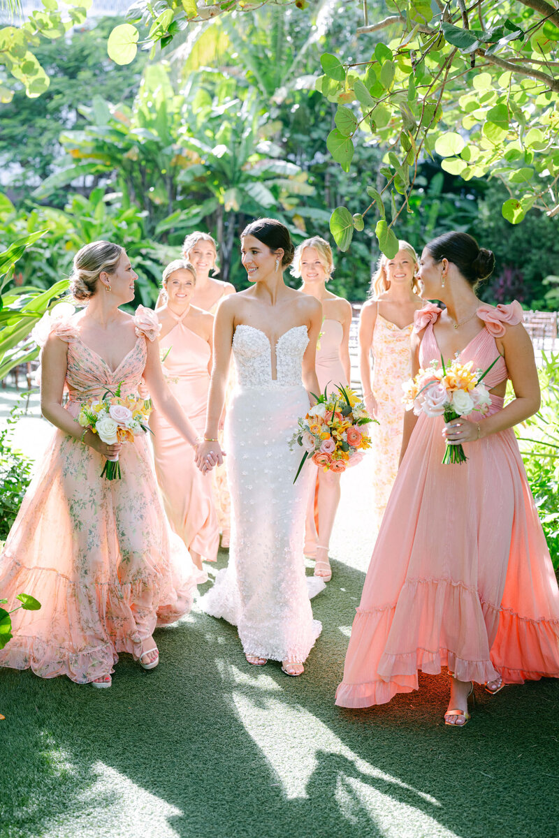 Bride and bridesmaids at Rosewood Baha mar, wearing blush and pink floral dresses