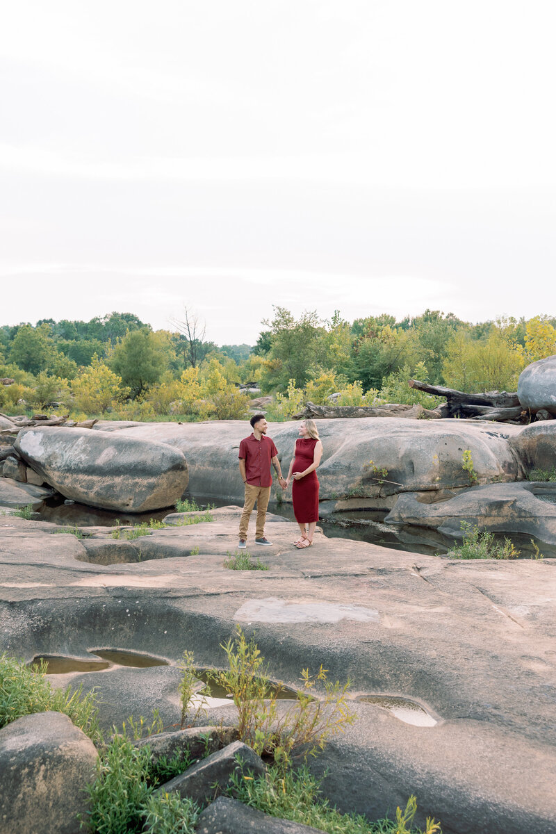Expecting couple embracing during a scenic outdoor maternity shoot in Richmond, VA