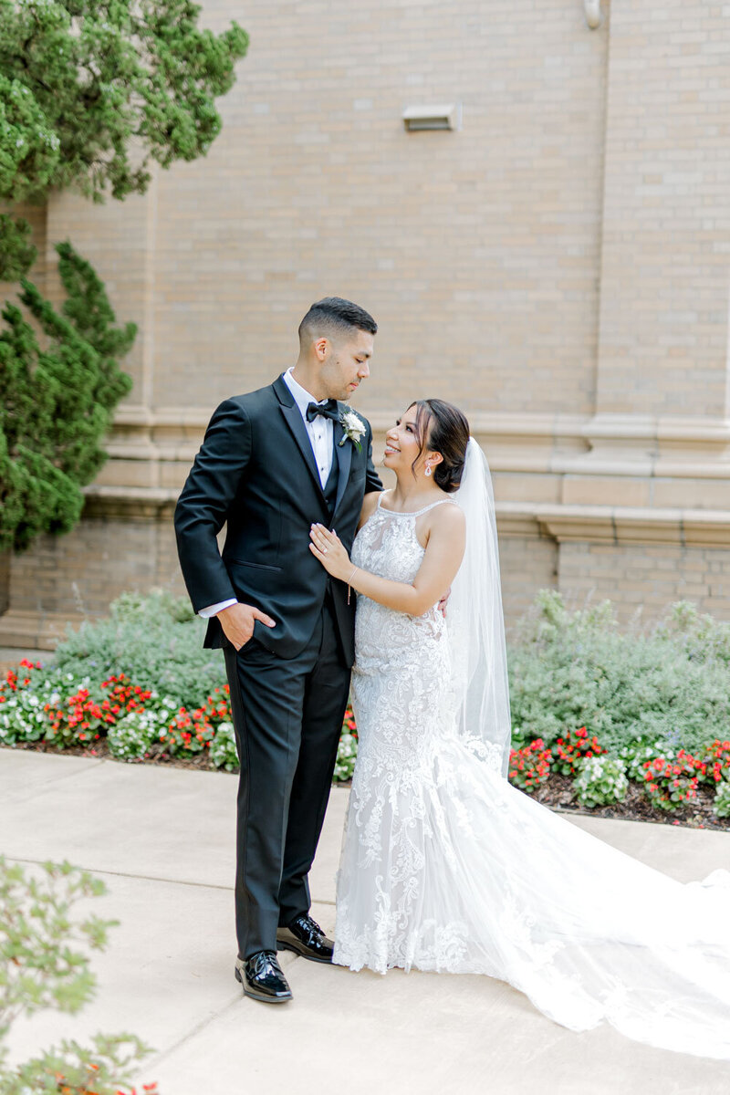 Bride and groom portrait outside with garden flowers