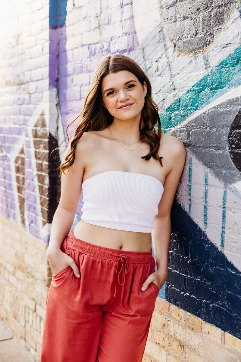 beautiful high school senior showing off her makeup look that was carefully perfected by Stephanie Schuh, a makeup artist in Oshkosh 
