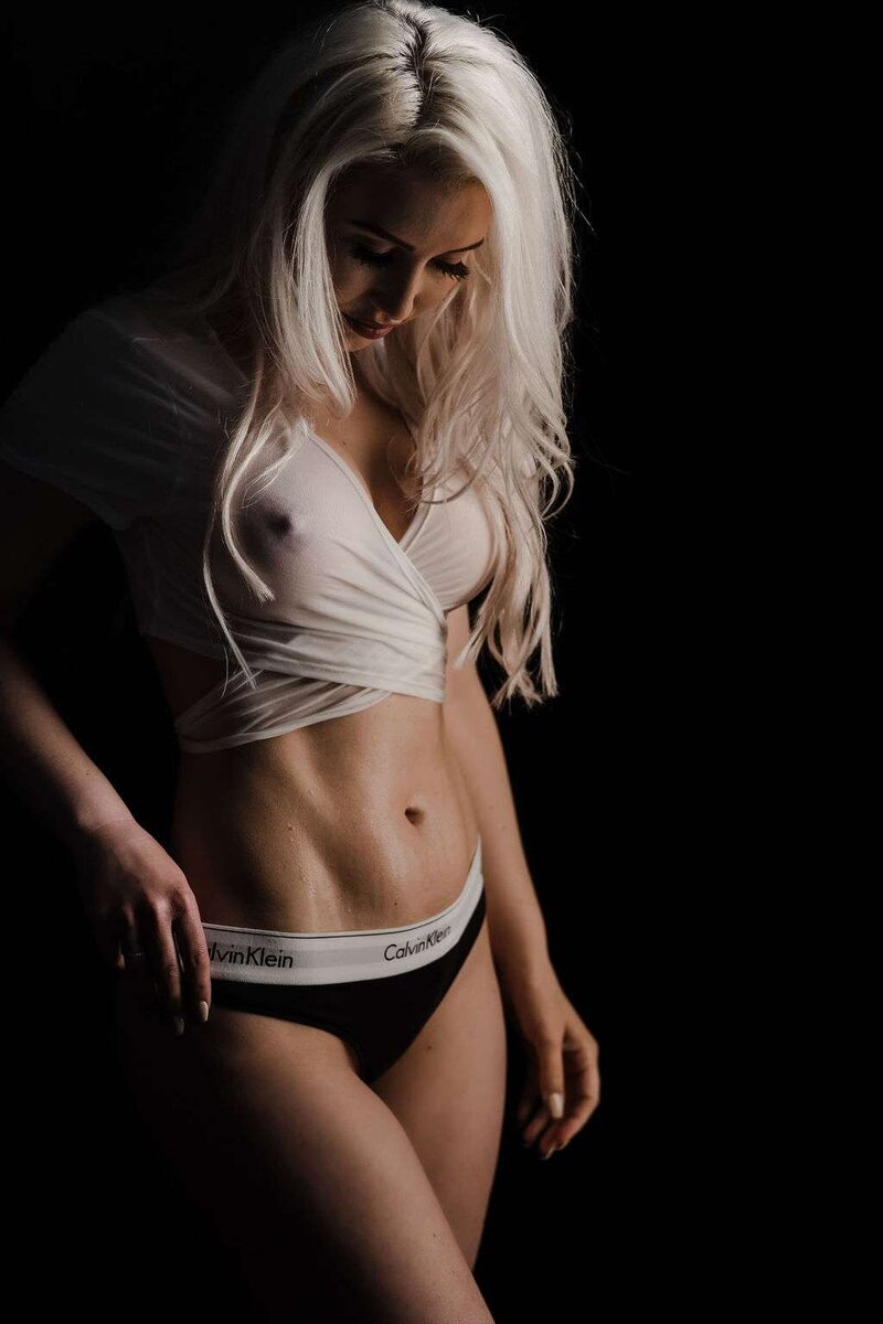 Looking down from the camera during a wet t-shirt photoshoot in a Vancouver Boudoir Session