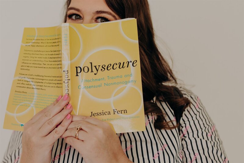 woman holding up a yellow book named polysecure