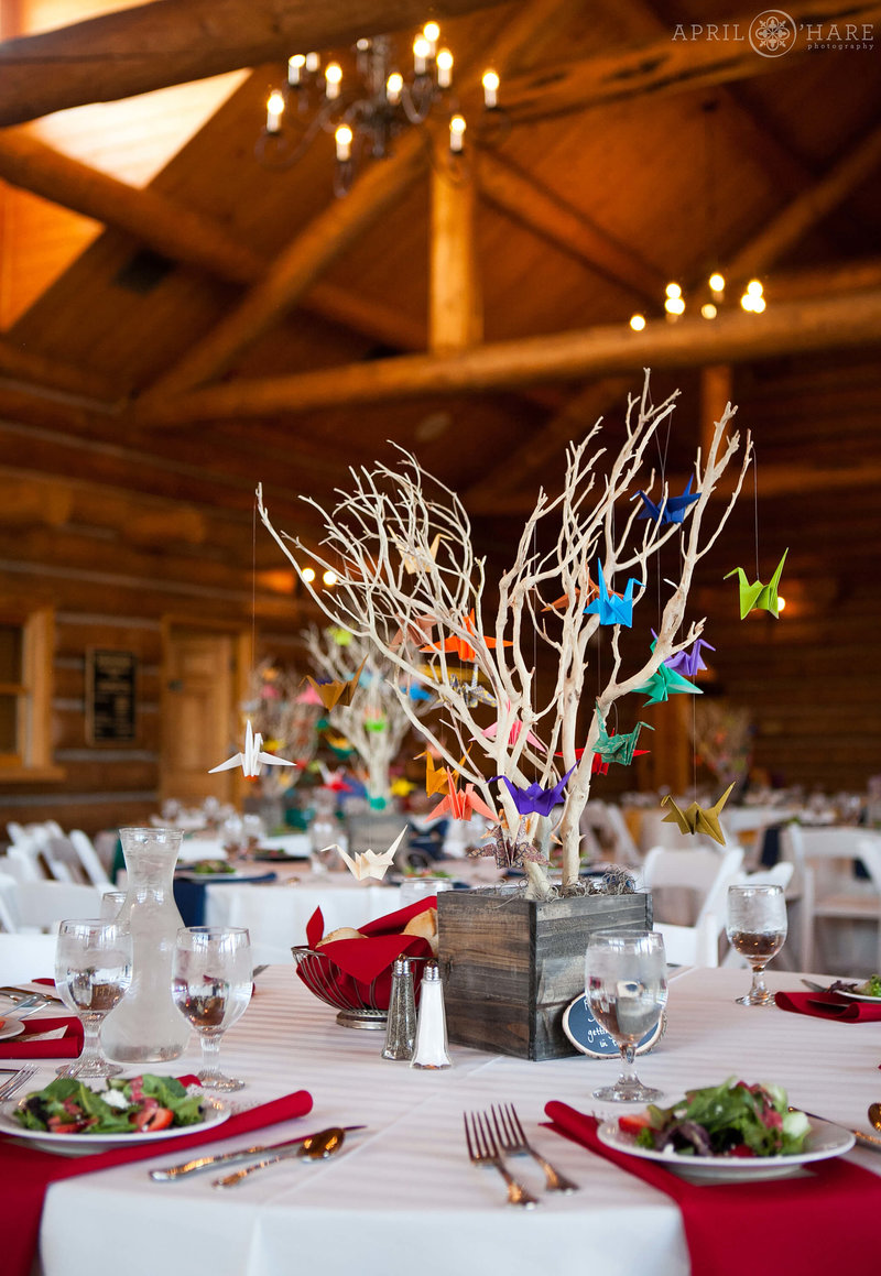 Cute paper cranes made with rainbow colored paper decorate a table inside the Evergreen Lake House in Colorado