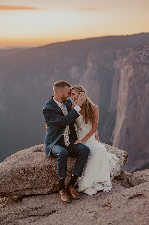 yosemite elopement photographer -bride and groom laughing together at Taft Point in Yosemite with sunset and alpenglow