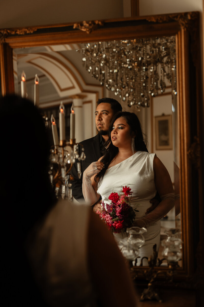 bride and grooms reflection in mirror at the chateau