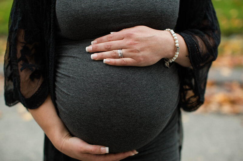 Expectant mom holding her belly with her hand on her top waiting for baby to arrive