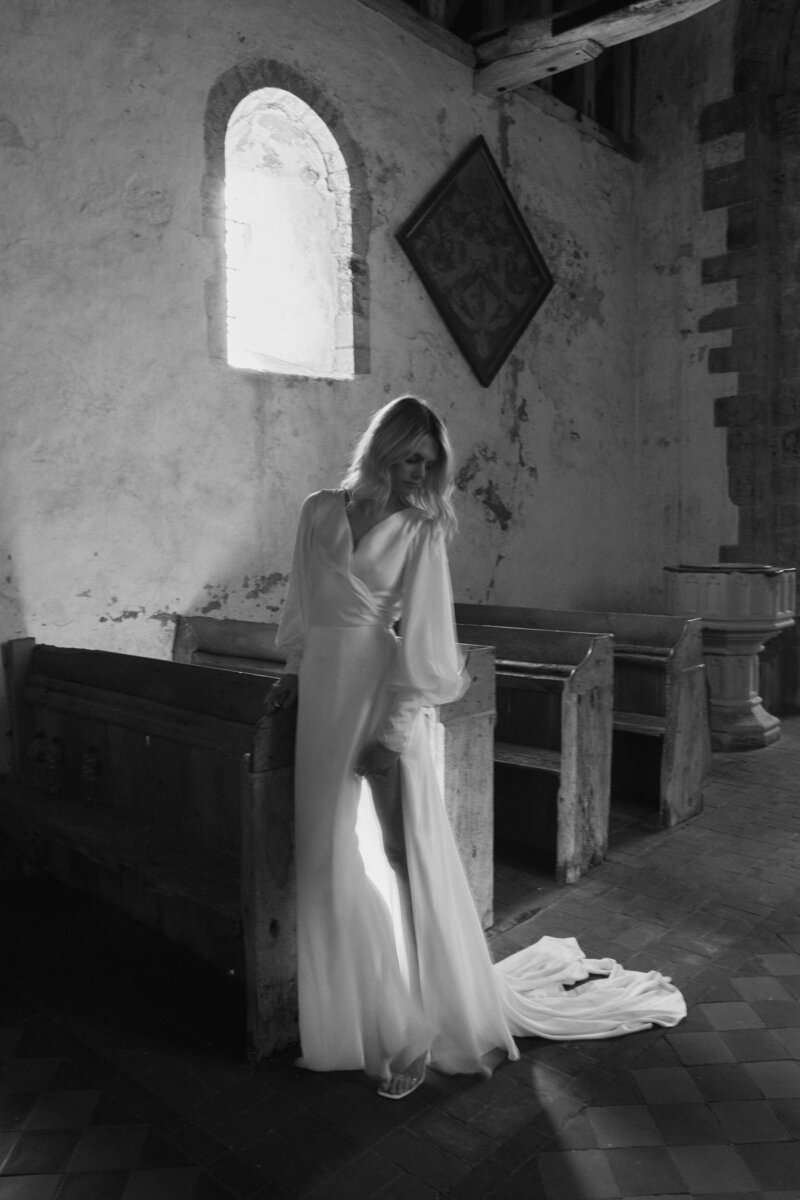 Sustainable wedding dress handmade in silk from british designer on bride in chapel