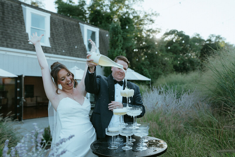 couple pouring champagne on their wedding day, captured by Elsie Goodman, an NYC wedding, engagement and couples photographer