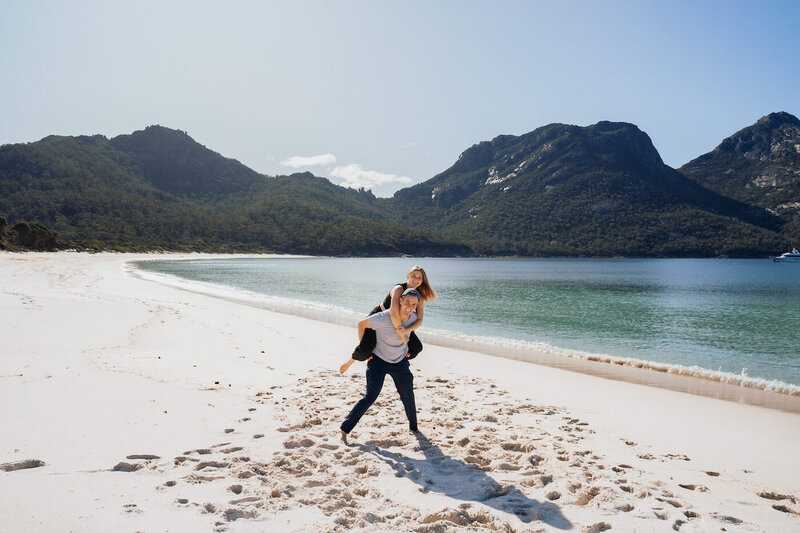 Couple during engagement photos on Wineglass Bay in Tasmania