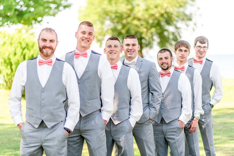 Groomsmen pose with their hands in their pockets