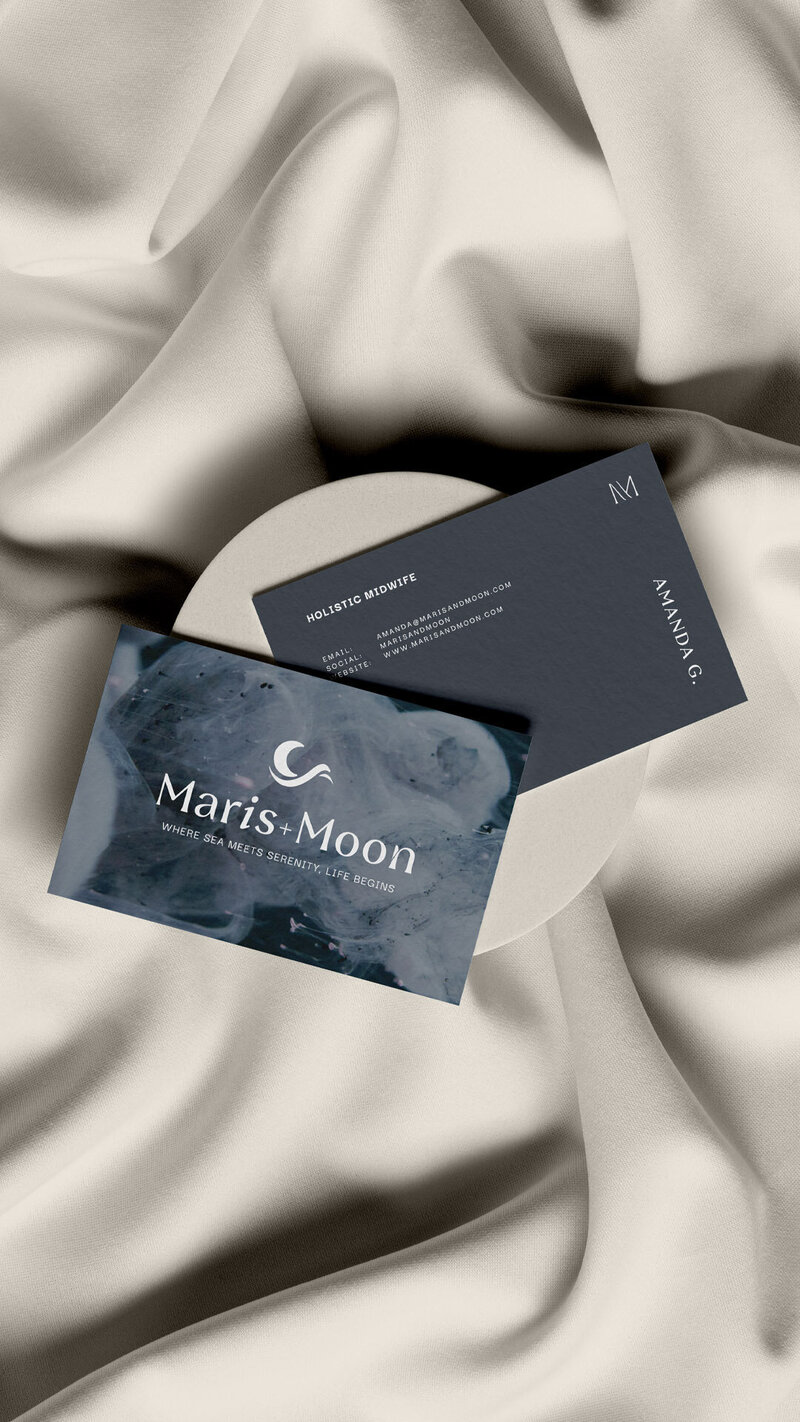 A stylish business card mockup for a midwife brand by Unica Formo, set against a clean white cloth.