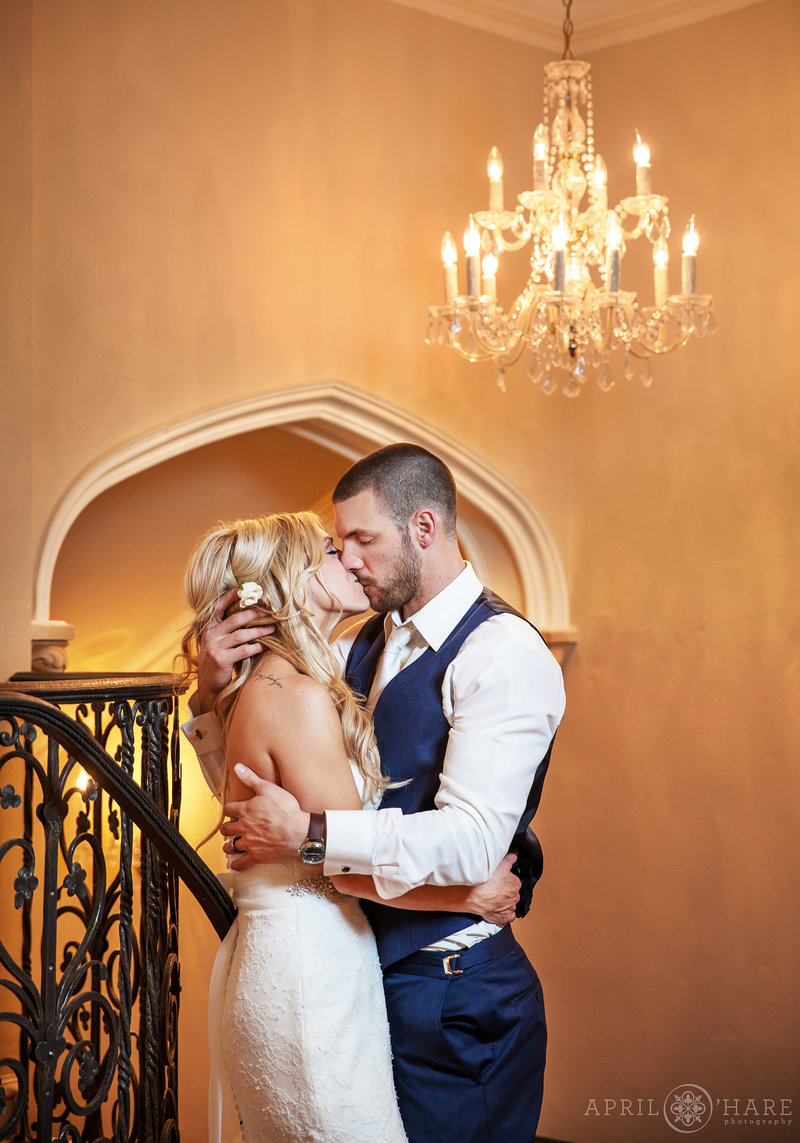 Vintage castle wedding portrait with chandelier and detailed archway at Highlands Ranch Mansion