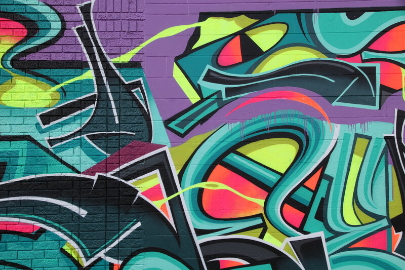Street art on a purple wall