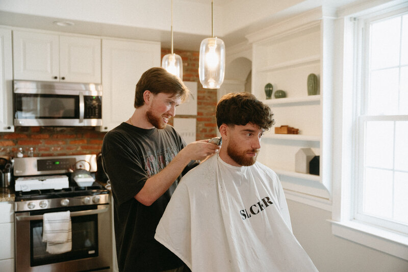 groom getting hair cut on wedding day