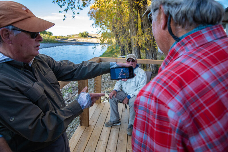 Men sharing fishing photos