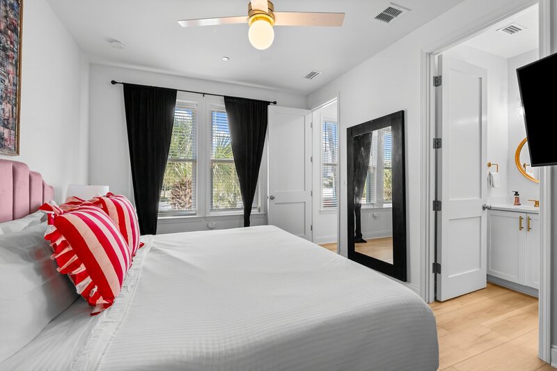 View from the king bedroom into private en-suite bathroom, with dramatic curtains and glam finishes—perfect for relaxing in style near Santa Rosa Beach.