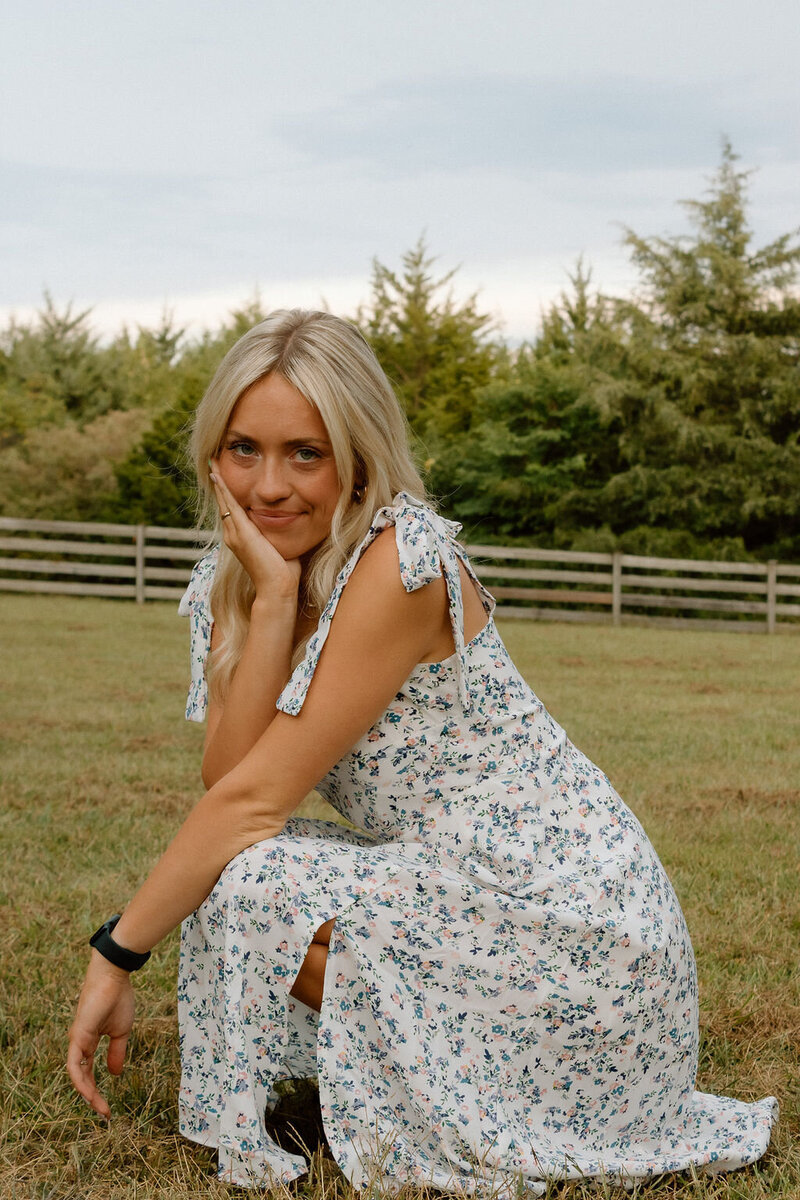 girl poses in dress for senior photos in kansas city missouri