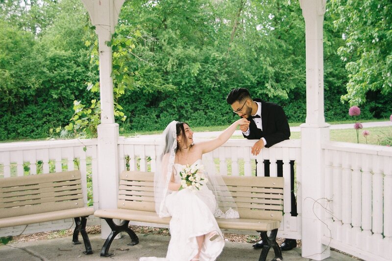A spontaneous, joy-filled moment of a newlywed couple laughing together in the streets of Old Montreal.