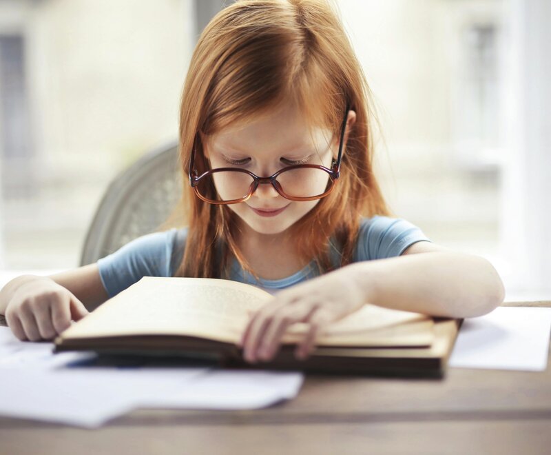 A child participating in an Evidence-Based Literacy Instruction (EBLI) lesson, focusing on improving reading fluency.