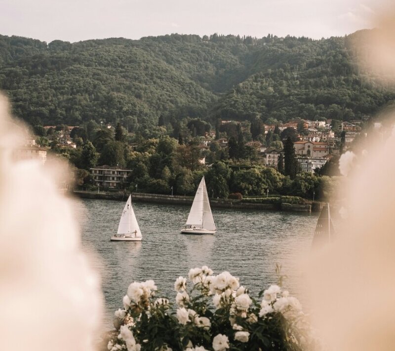 Watching two sailboats float by in picturesque european seaside town