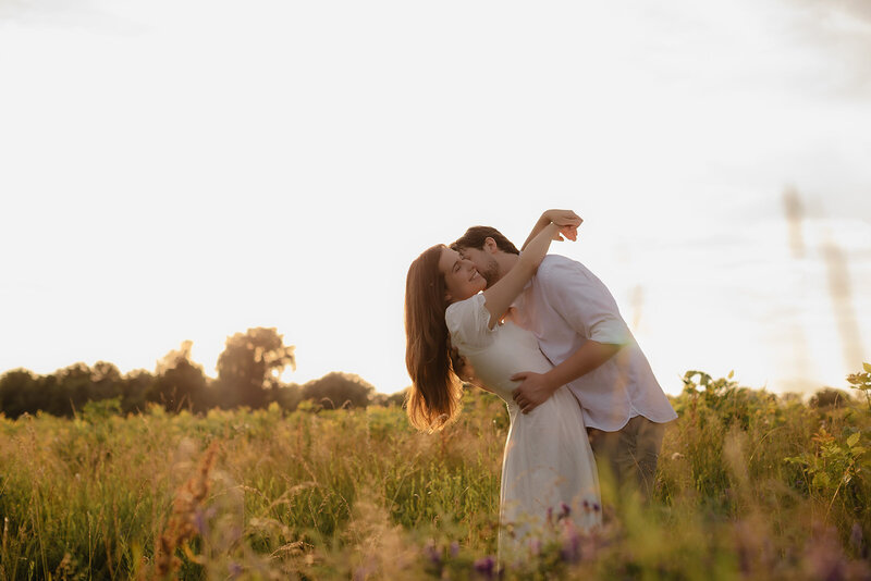 man carried woman in this arms for engagement session on the beach