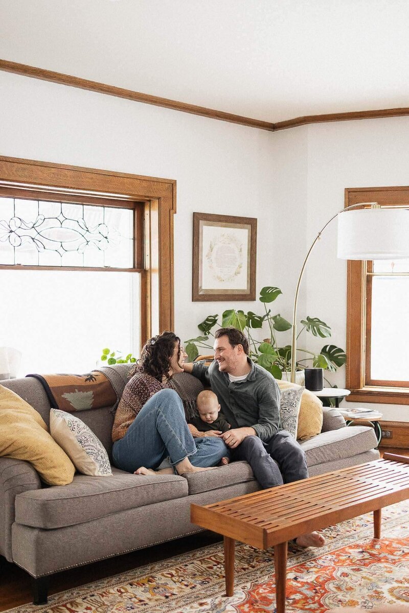 A family shares a warm moment in their living room, surrounded by natural light and cozy decor. Perfectly captured family photography in Cleveland.