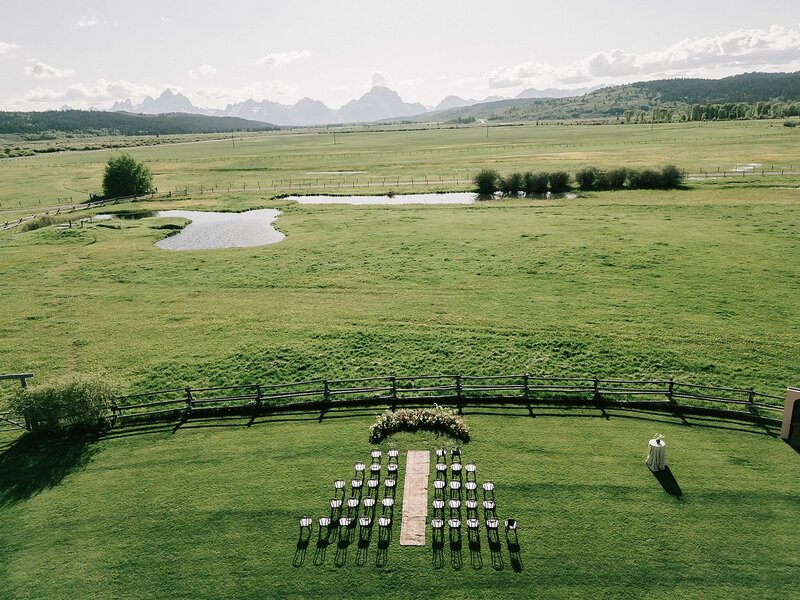 groom kissing the side of brides face  in their getaway vehicle after their jackson hole wedding.