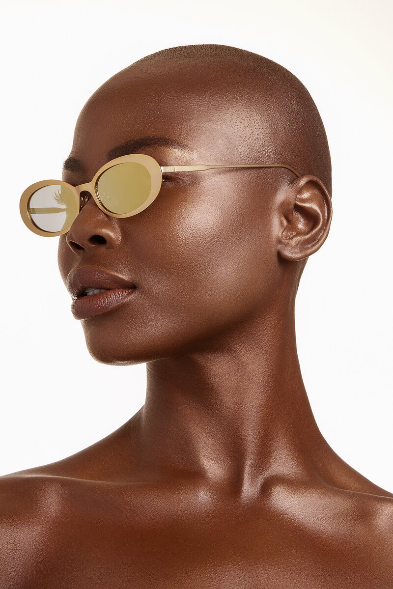 woman with gold sunglasses at cosmetic photography shoot