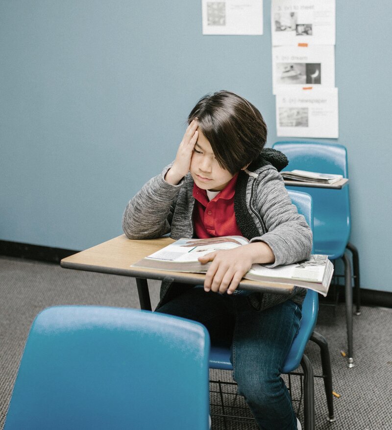 An unhappy and stressed child at school