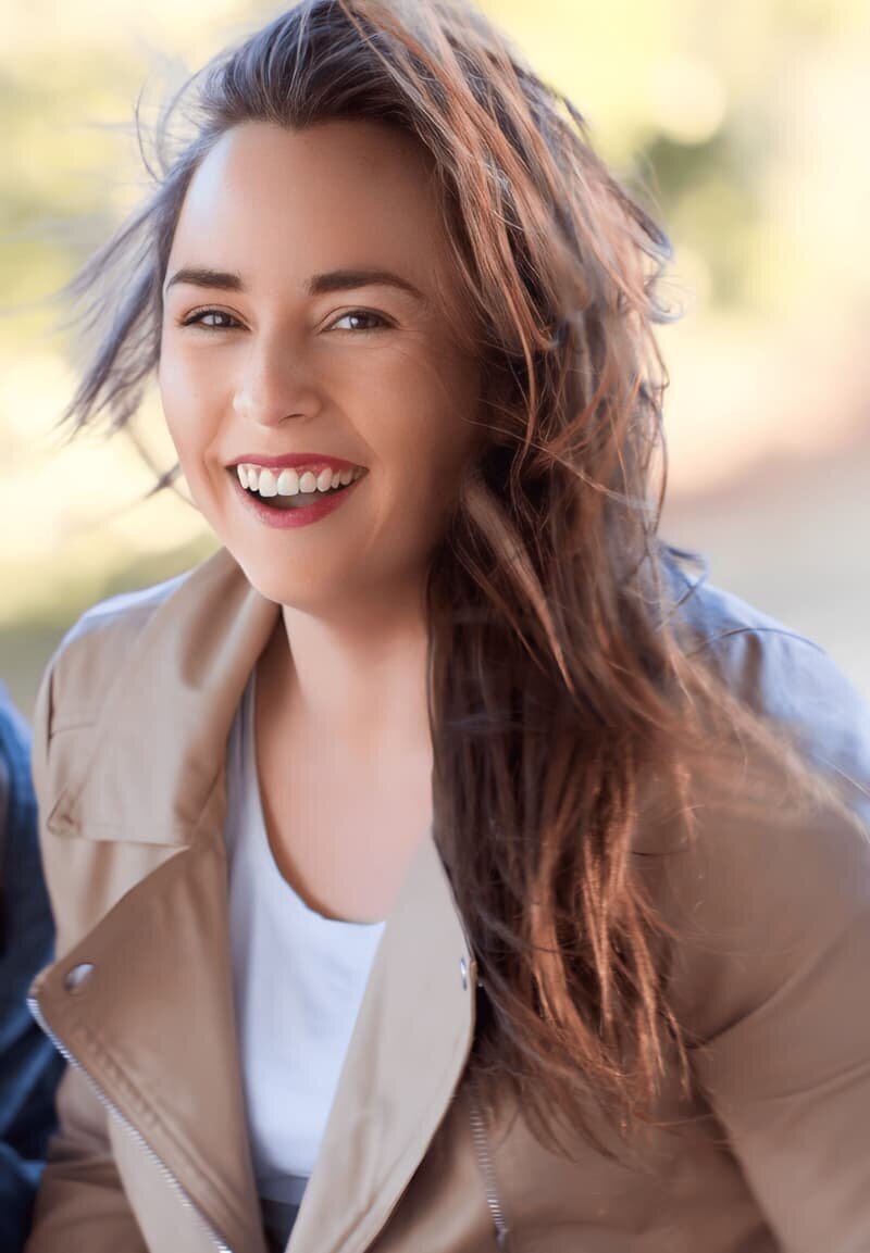 Rachelle Deem laughing warmly, conveying approachability and friendliness in website design and course creation