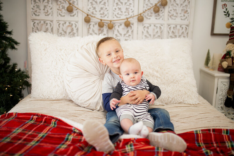 Brothers together for christmas photos wearing red and white