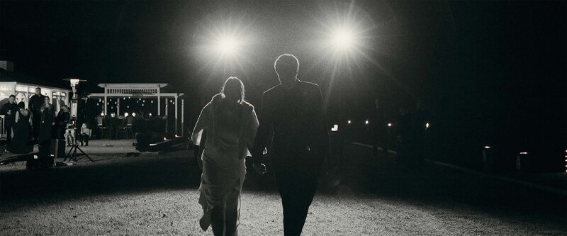 bride-and-groom-walking-backlit