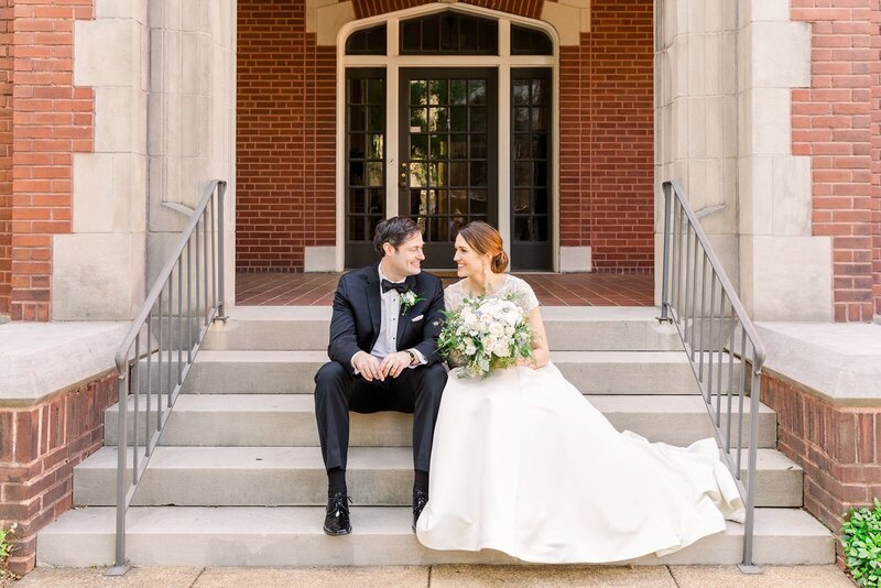Bride and groom sit on Birmingham church steps