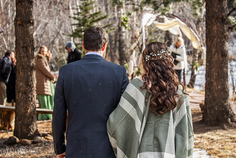 Couple Walk to their Winter Wedding at Romantic Riversong Inn Estes Park CO