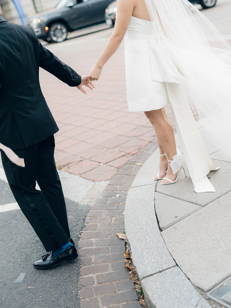 bride and groom walking across street taken by dc film wedding photographer