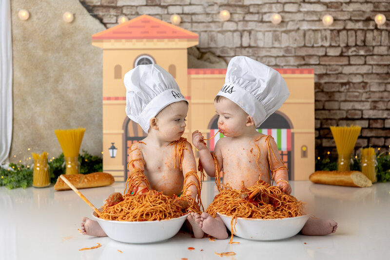 Twin boys share a meal in an Italian themed pasta smash