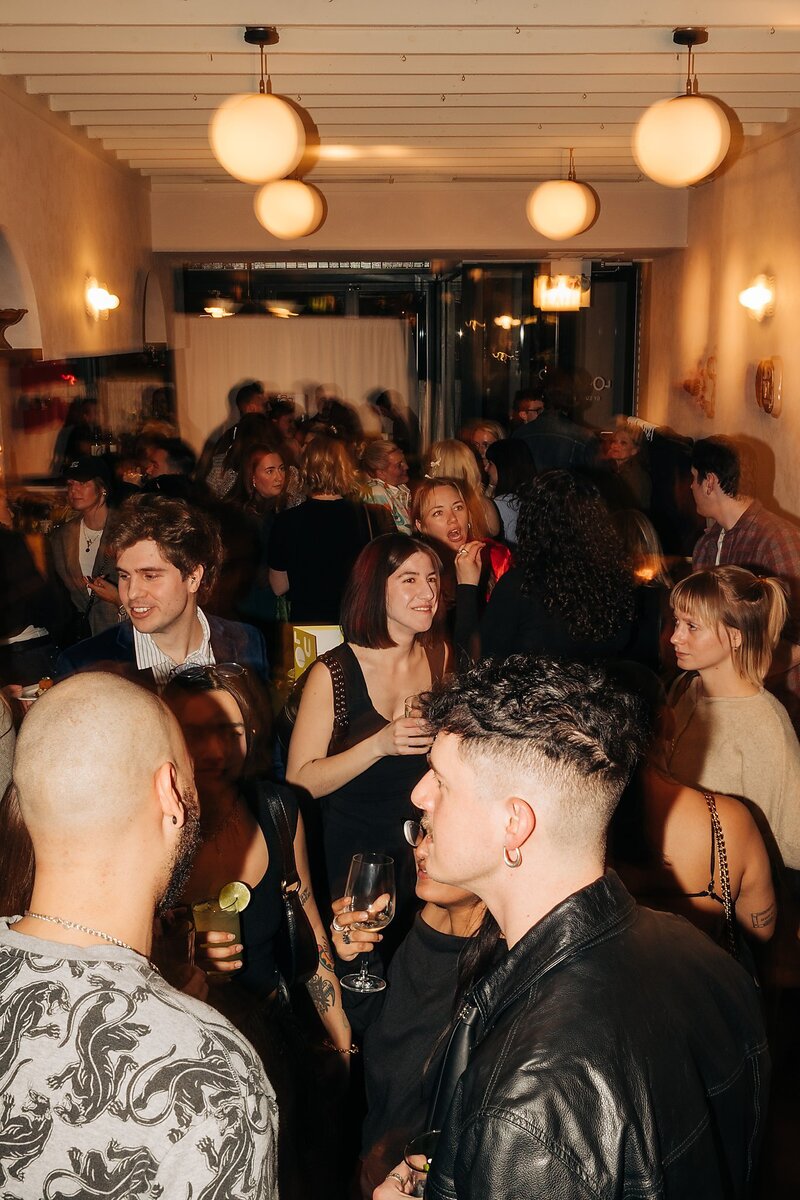 Friends toasting and celebrating during Dart Collective Chicago launch at Lou Lou by Lola Cafe