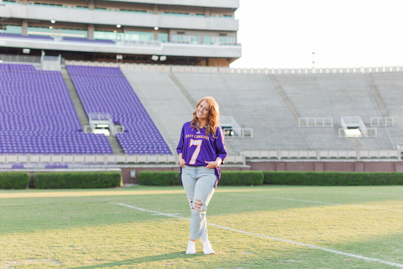 Girl in a jersey in the football stadium