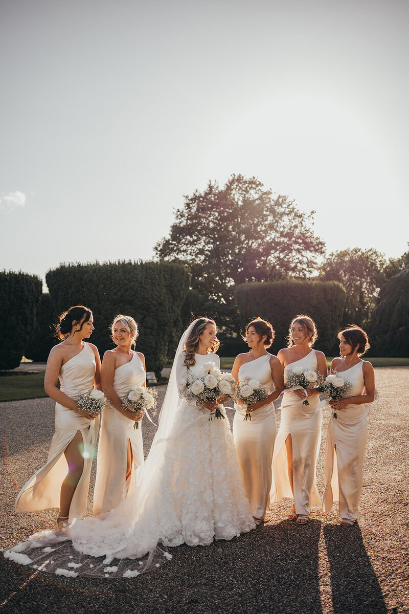 bride poses with her bridesmaids