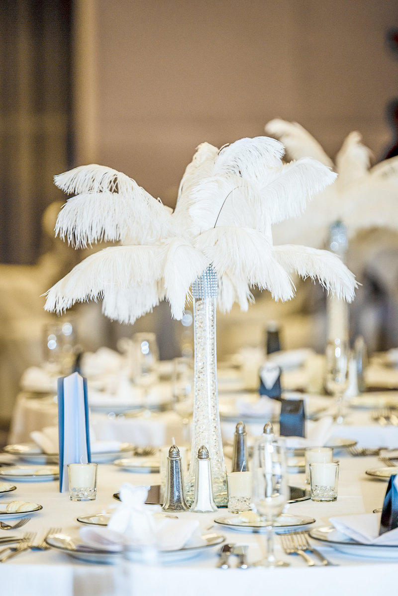 White feather centerpieces for wedding tables